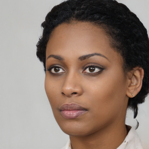 Neutral black young-adult female with short  black hair and brown eyes