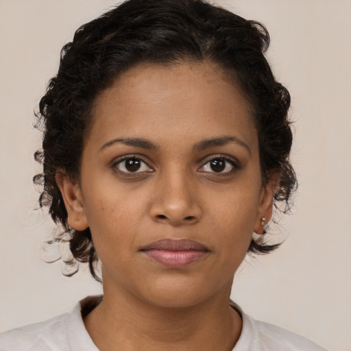 Joyful black young-adult female with medium  brown hair and brown eyes