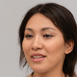 Joyful asian young-adult female with long  brown hair and brown eyes