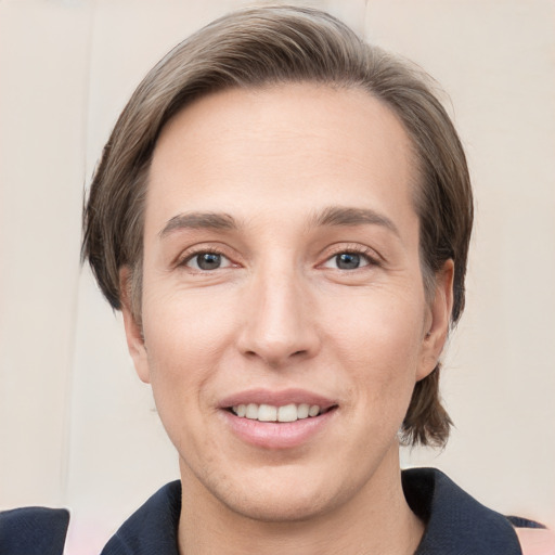 Joyful white young-adult male with medium  brown hair and grey eyes