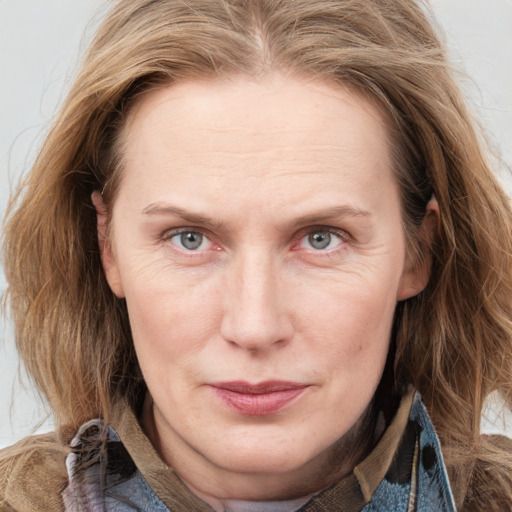 Joyful white adult female with medium  brown hair and grey eyes