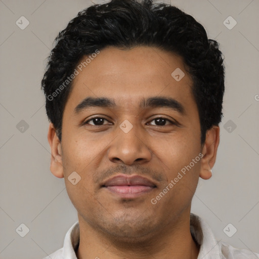 Joyful latino young-adult male with short  black hair and brown eyes