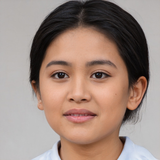 Joyful latino young-adult female with medium  brown hair and brown eyes