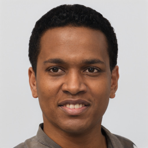 Joyful black young-adult male with short  black hair and brown eyes