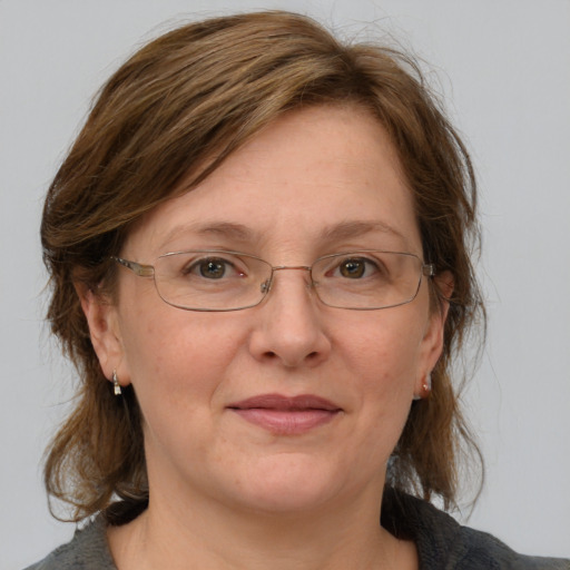 Joyful white adult female with medium  brown hair and grey eyes