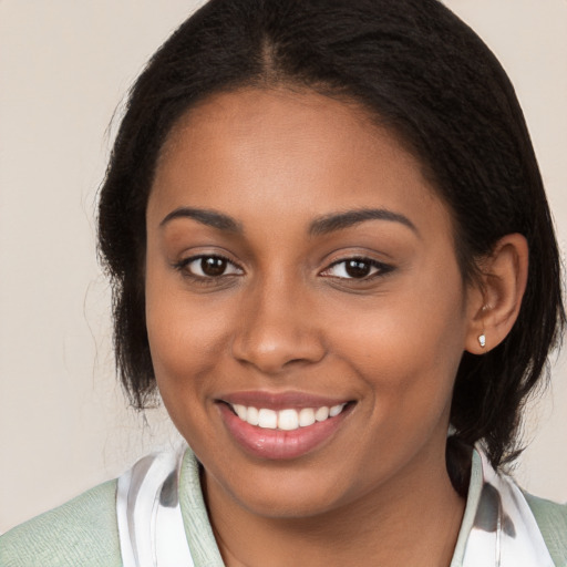 Joyful black young-adult female with medium  brown hair and brown eyes