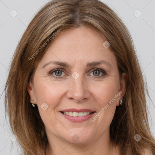 Joyful white adult female with long  brown hair and grey eyes