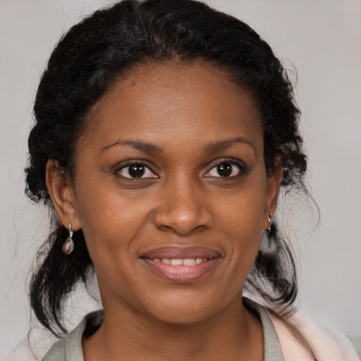 Joyful black young-adult female with medium  brown hair and brown eyes
