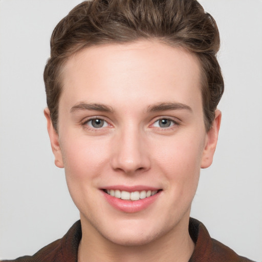 Joyful white young-adult female with short  brown hair and grey eyes