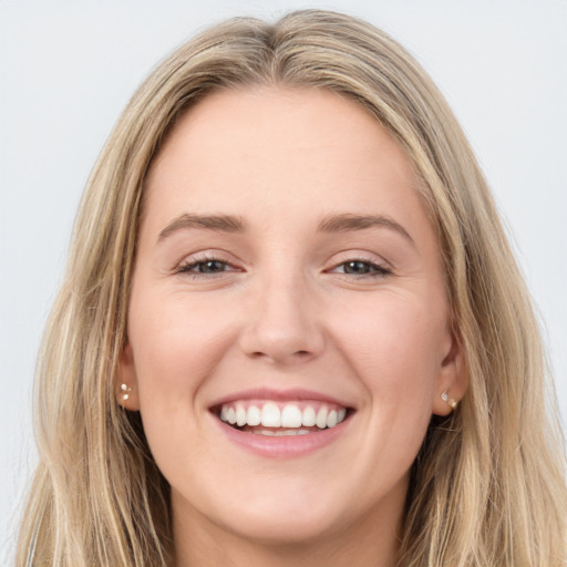 Joyful white young-adult female with long  brown hair and blue eyes