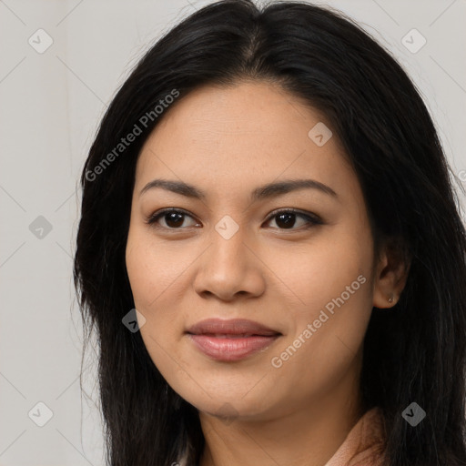 Joyful latino young-adult female with long  black hair and brown eyes