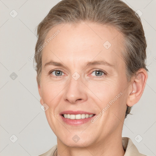 Joyful white adult female with short  brown hair and grey eyes