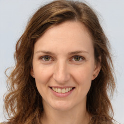 Joyful white young-adult female with long  brown hair and green eyes