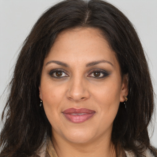 Joyful white adult female with long  brown hair and brown eyes