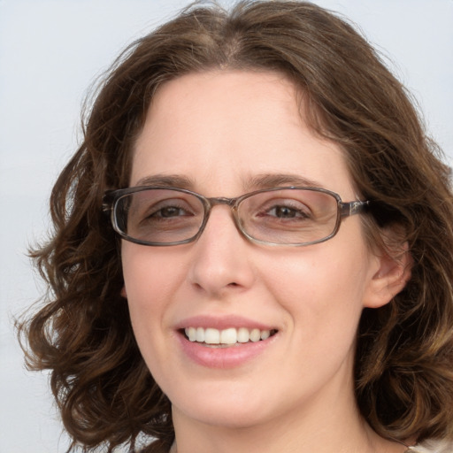 Joyful white young-adult female with medium  brown hair and green eyes