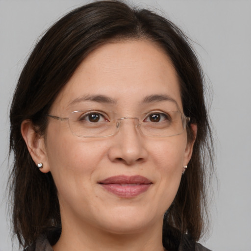 Joyful white adult female with medium  brown hair and brown eyes