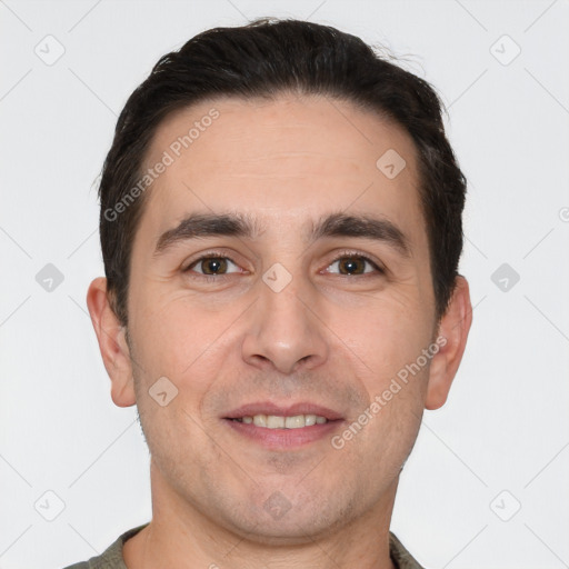 Joyful white young-adult male with short  brown hair and brown eyes