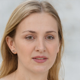 Joyful white young-adult female with long  brown hair and blue eyes