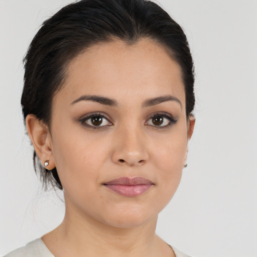 Joyful latino young-adult female with medium  brown hair and brown eyes