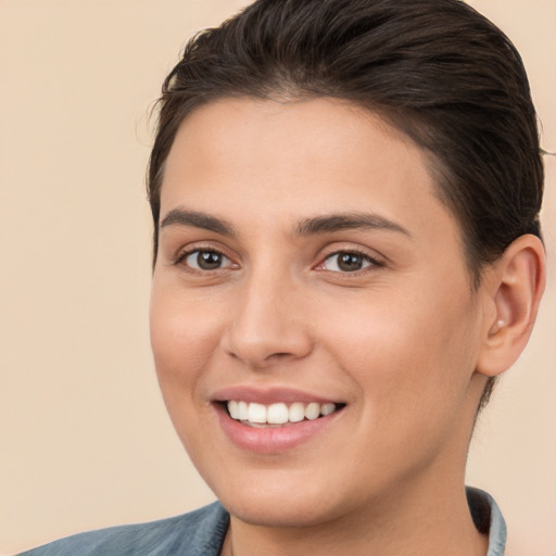 Joyful white young-adult female with short  brown hair and brown eyes