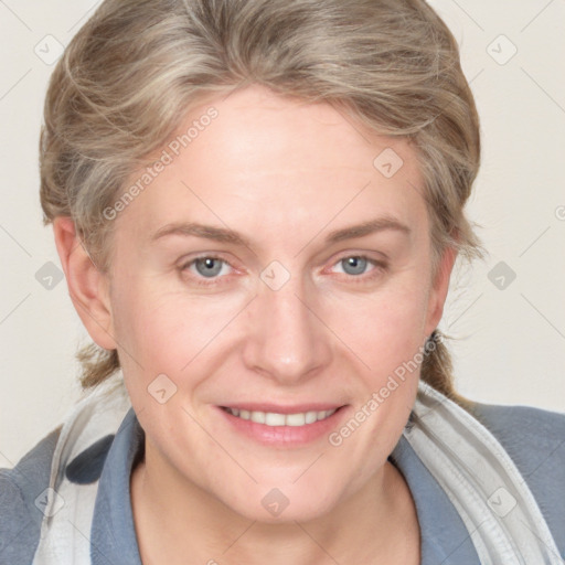 Joyful white adult female with medium  brown hair and blue eyes