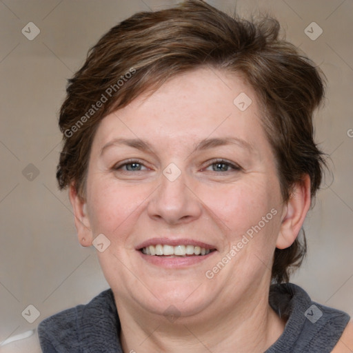 Joyful white adult female with medium  brown hair and blue eyes