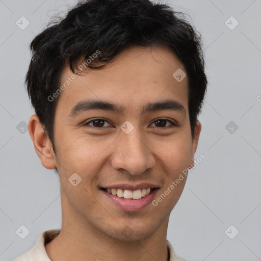 Joyful latino young-adult male with short  brown hair and brown eyes