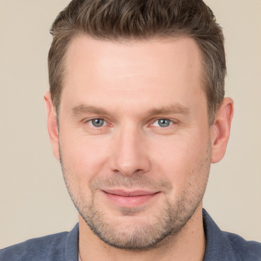 Joyful white young-adult male with short  brown hair and brown eyes