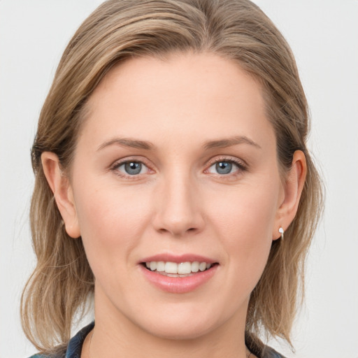 Joyful white young-adult female with medium  brown hair and blue eyes