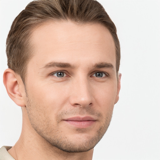 Joyful white young-adult male with short  brown hair and grey eyes