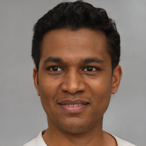 Joyful latino young-adult male with short  black hair and brown eyes