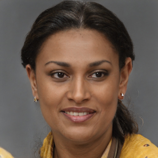 Joyful black young-adult female with medium  brown hair and brown eyes