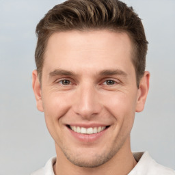 Joyful white young-adult male with short  brown hair and brown eyes