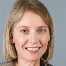 Joyful white young-adult female with medium  brown hair and blue eyes