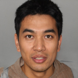 Joyful asian young-adult male with short  black hair and brown eyes