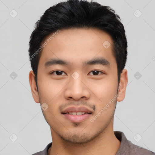 Joyful asian young-adult male with short  black hair and brown eyes