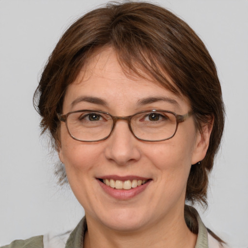 Joyful white adult female with medium  brown hair and brown eyes