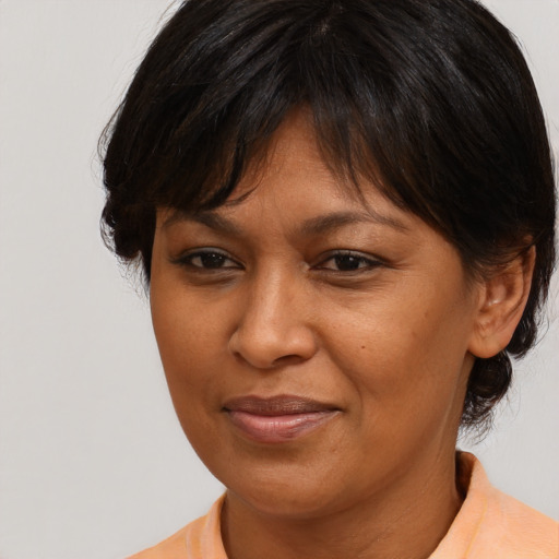 Joyful asian adult female with medium  brown hair and brown eyes
