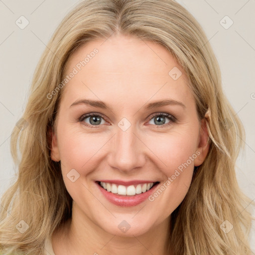 Joyful white young-adult female with long  brown hair and blue eyes