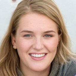 Joyful white young-adult female with long  brown hair and blue eyes