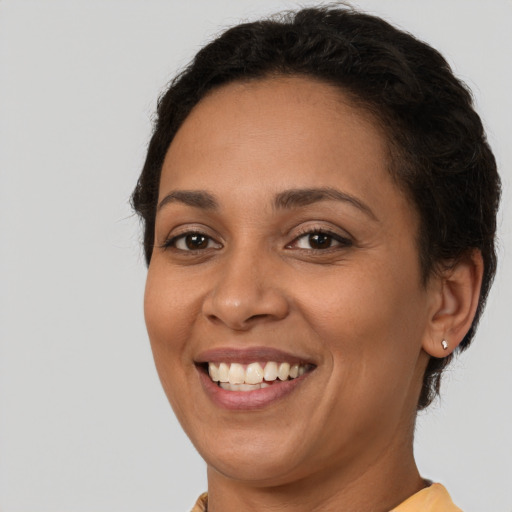 Joyful latino young-adult female with short  brown hair and brown eyes