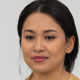 Joyful asian young-adult female with medium  brown hair and brown eyes