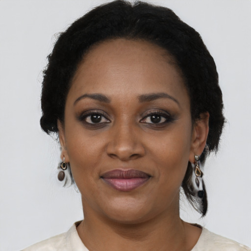 Joyful black young-adult female with short  black hair and brown eyes