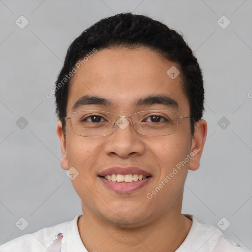 Joyful latino young-adult male with short  black hair and brown eyes