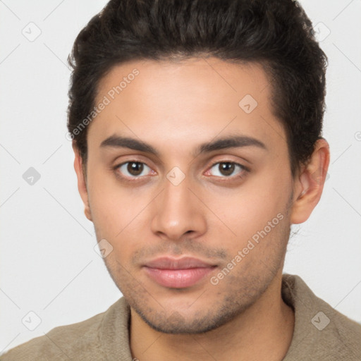 Joyful latino young-adult male with short  brown hair and brown eyes