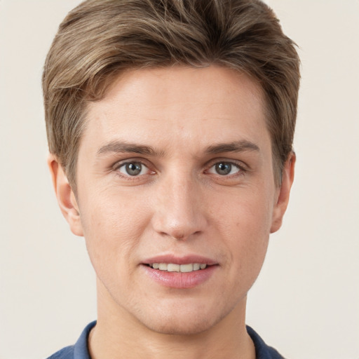 Joyful white young-adult male with short  brown hair and grey eyes