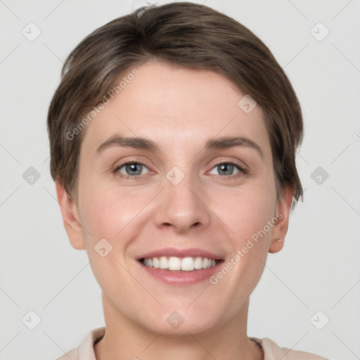 Joyful white young-adult female with short  brown hair and grey eyes