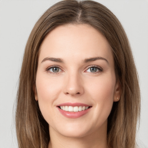 Joyful white young-adult female with long  brown hair and grey eyes