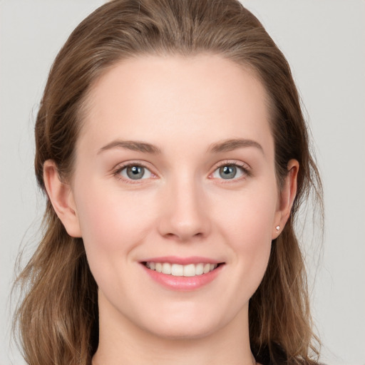 Joyful white young-adult female with long  brown hair and grey eyes