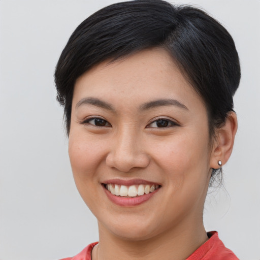Joyful asian young-adult female with medium  brown hair and brown eyes